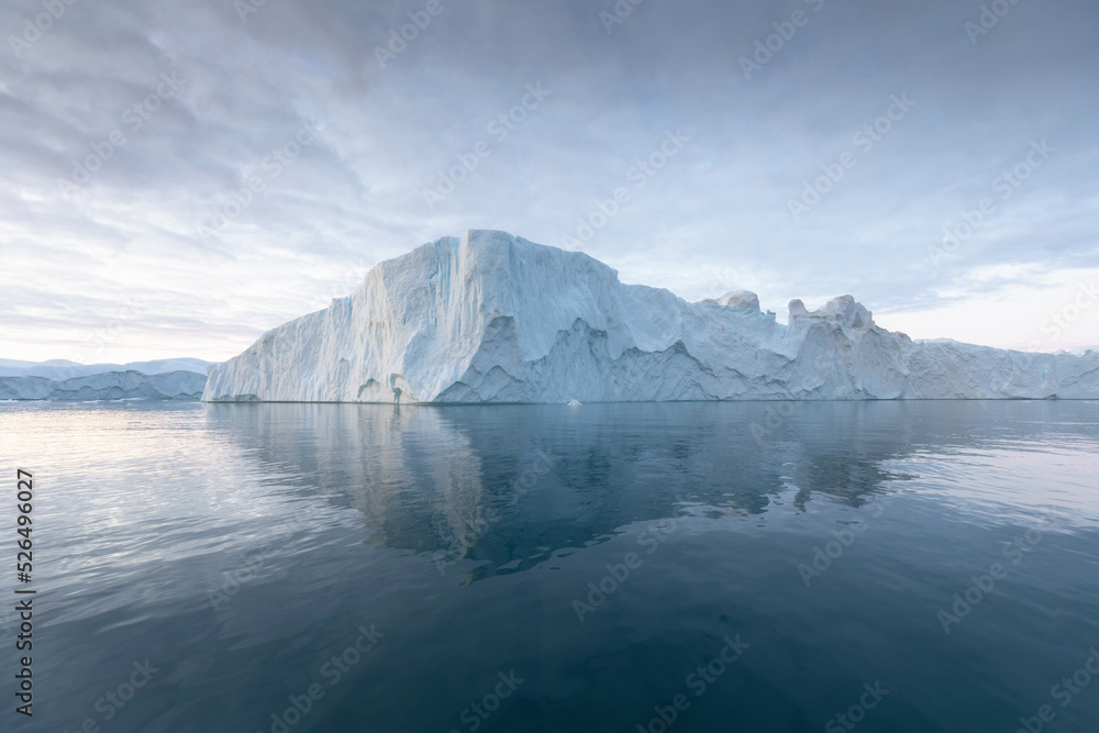 Climate change and global warming. Icebergs from a melting glacier in Greenland. The icy landscape of the Arctic nature in the UNESCO world heritage site. Summer season