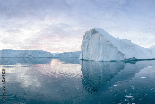 Climate change and global warming. Icebergs from a melting glacier in Greenland. The icy landscape of the Arctic nature in the UNESCO world heritage site. Summer season © Michal