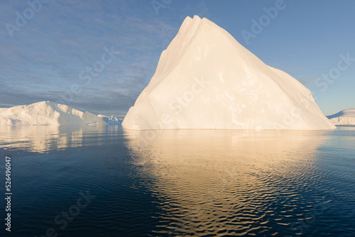 Climate change and global warming. Icebergs from a melting glacier in Greenland. The icy landscape of the Arctic nature in the UNESCO world heritage site. Summer season