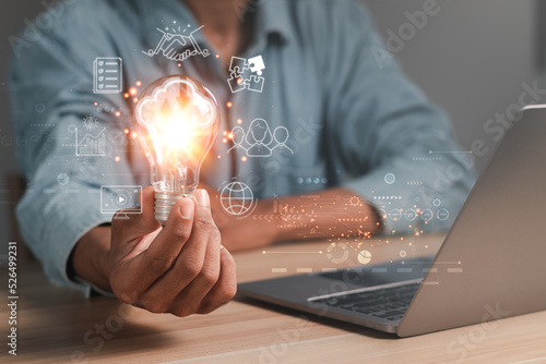 Hand holding light bulb with cloud computing icon and global internet connection technology. Global Business and Digital Marketing, Internet Connectivity, Finance and Banking. digital link technology photo