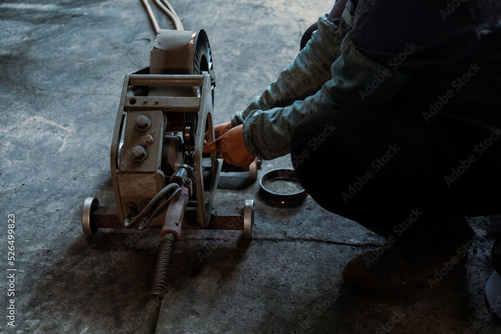 Closeup of welder preparing welding machine