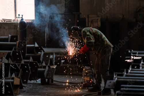 Industrial welder welding metal profiles
