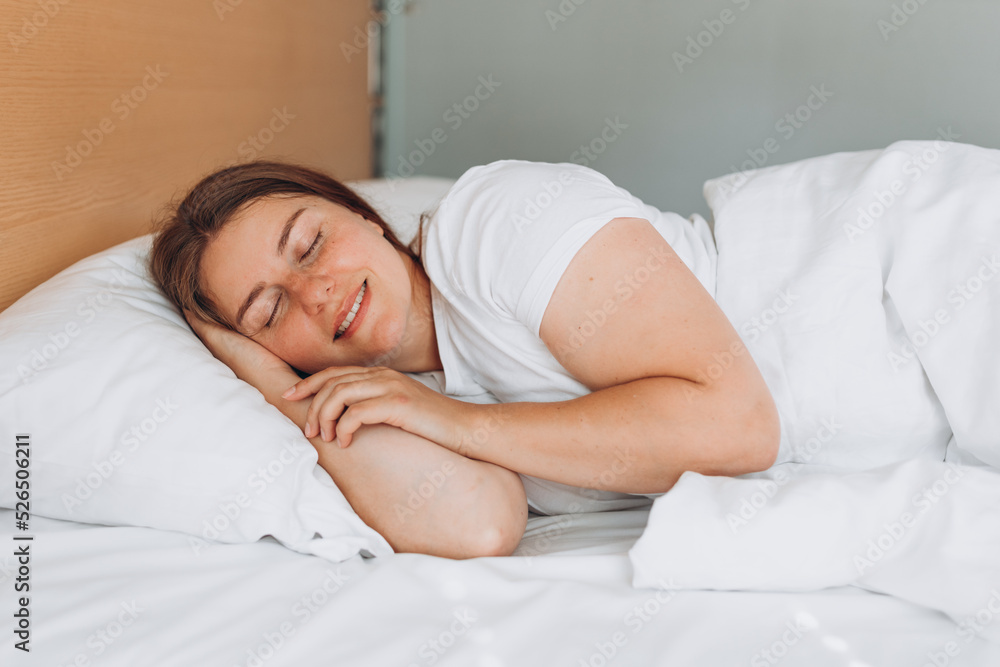 Young beautiful woman sleeping in bed at home. Millennial Caucasian girl sleeping on soft pillow, enjoying sweet dreams good night rest in bed. Photo of sleeping woman lies in bed with eyes closed. Young beautiful woman sleeping in bed at home. Millennial Caucasian girl sleeping on soft pillow, enjoying sweet dreams good night rest in bed. Photo of sleeping woman lies in bed with eyes closed.