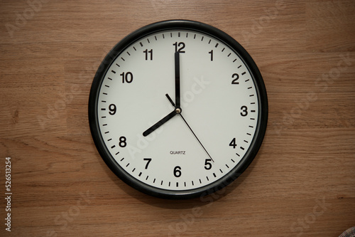 office wall clock indicating the eight o clock hour