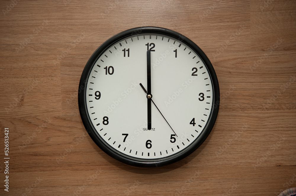 office wall clock indicating the six o clock hour office wall clock indicating the six o clock hour
