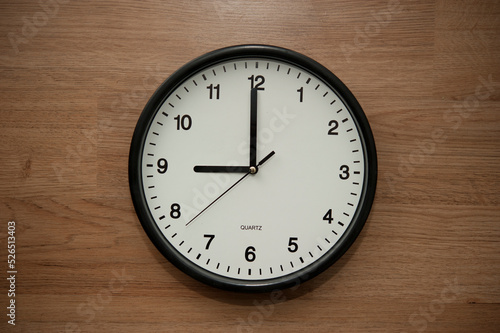 office wall clock indicating the nine o clock hour