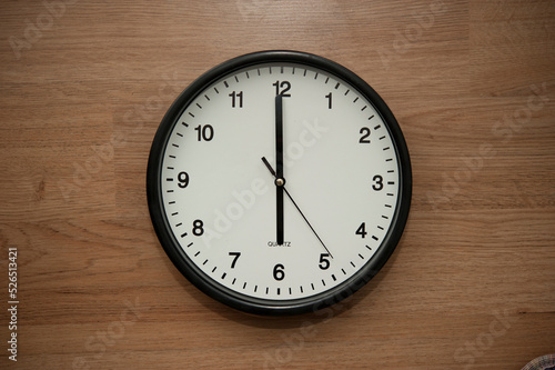 office wall clock indicating the six o clock hour