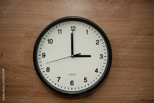 office wall clock indicating the three o clock hour