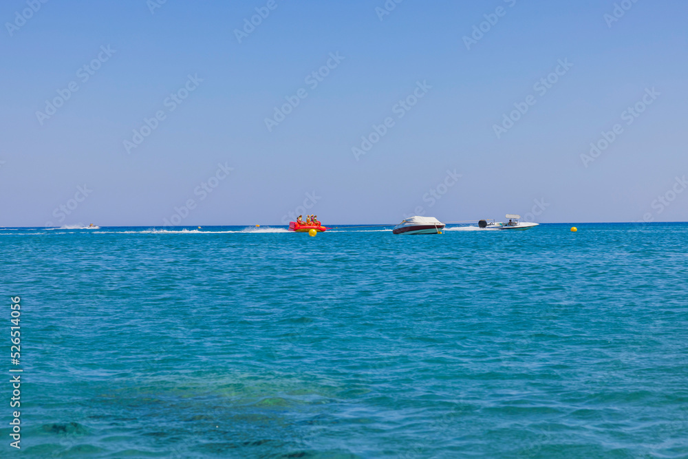 Beautiful view of sea activities for tourists. Blue sea water surface and blue sky background. Greece.
