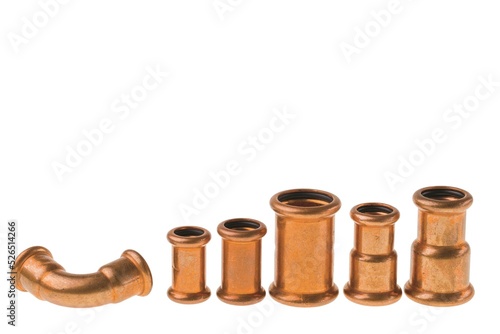 Close up view of copper reducing coupling of different sizes isolated on white background.