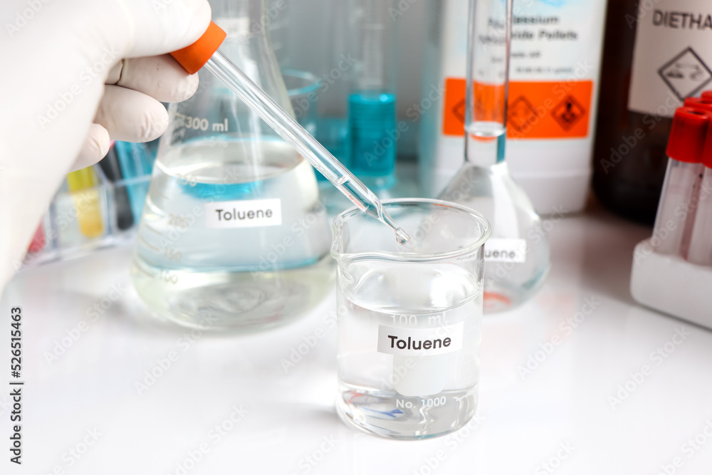 Toluene in glass, chemical in the laboratory Toluene in glass, chemical in the laboratory
