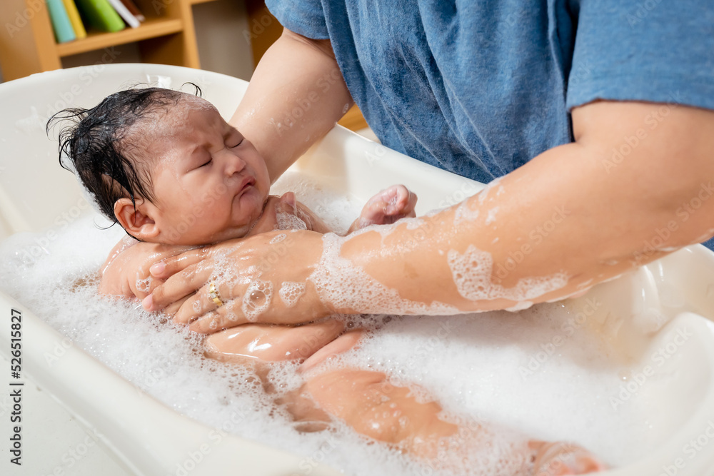 Single mother uses water to wash the soap off her body, and her infant daughter's face, After taking a shower at the end of the day, Mother bathed the girl during the day due to the hot weather. Single mother uses water to wash the soap off her body, and her infant daughter's face, After taking a shower at the end of the day, Mother bathed the girl during the day due to the hot weather.