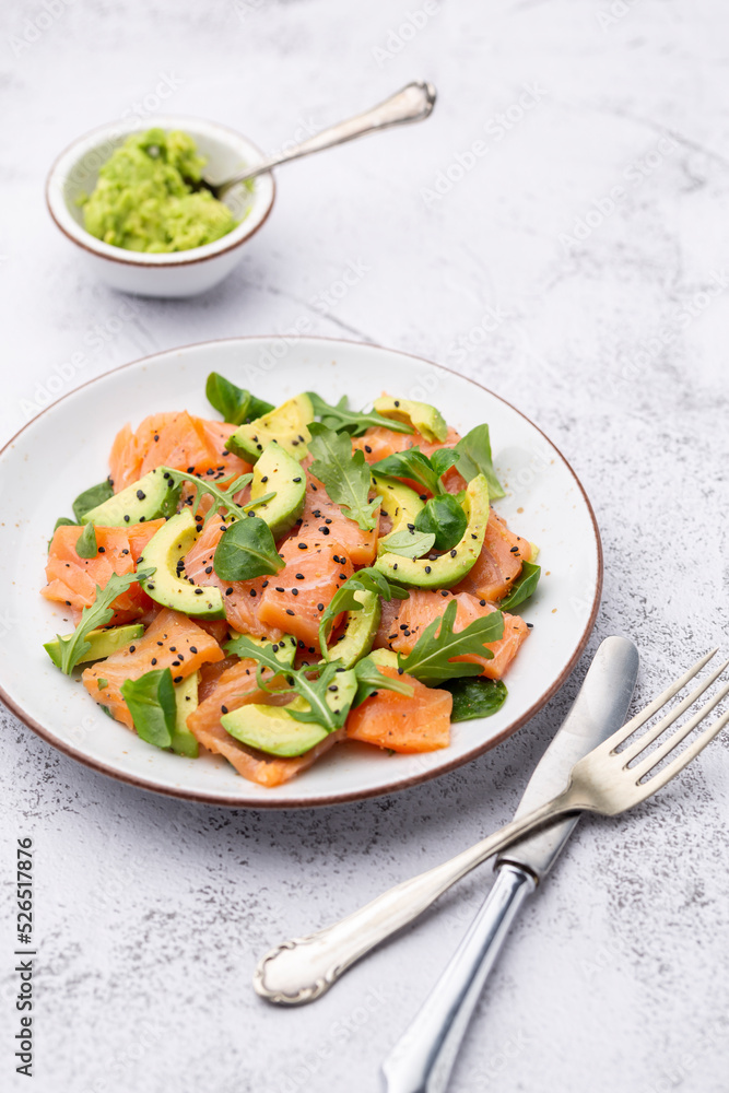 Salmon salad with avocado, for keto and low carb diet. Rusty background, top view, copy space. Salmon salad with avocado, for keto and low carb diet. Rusty background, top view, copy space.
