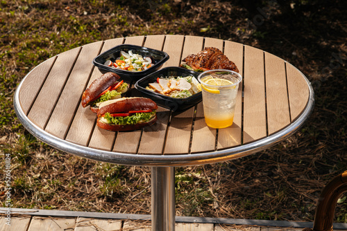 
sandwich with salads and drink on the table