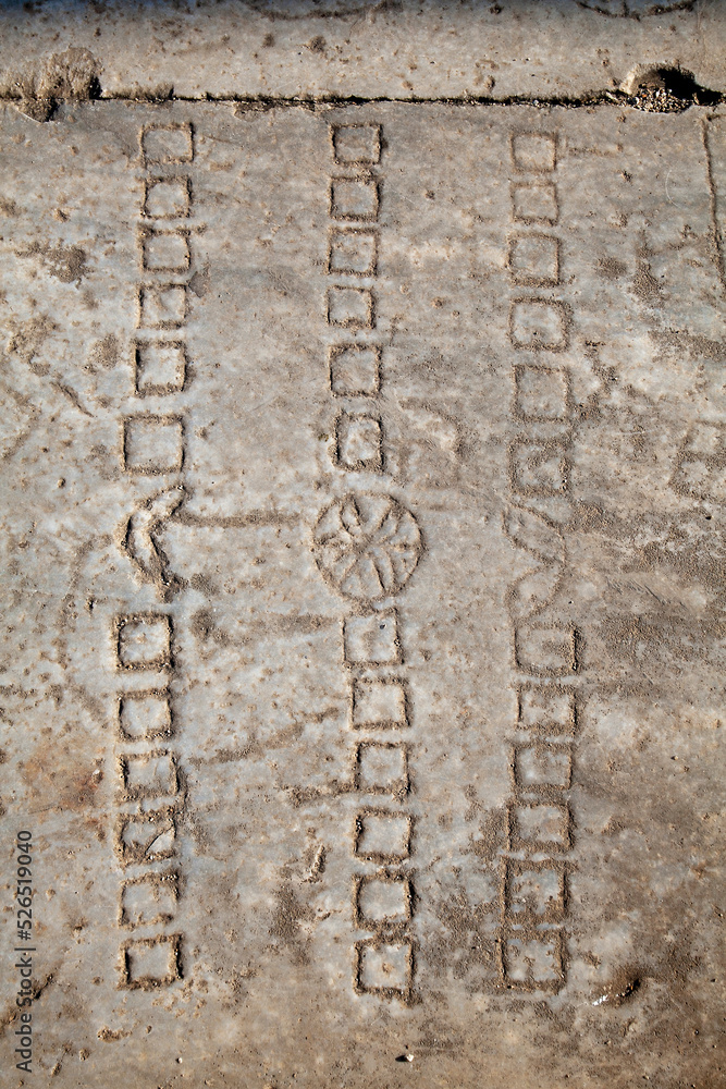 An ancient Roman game-stone carved in the floor. Didyma, Aydin, Turkey