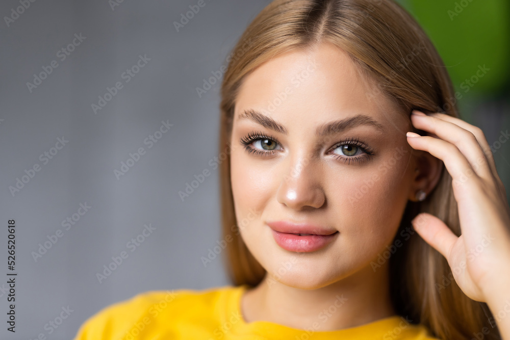 Attractive young woman sit sofa hold hand head good mood indoors inside apartment Attractive young woman sit sofa hold hand head good mood indoors inside apartment