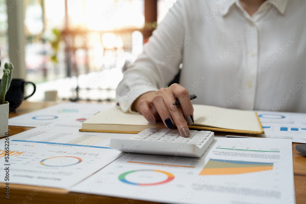 Finance and Investment, tax calculation and budget, Asian female entrepreneur using a calculator to calculate. Company business results document. Finance and Investment, tax calculation and budget, Asian female entrepreneur using a calculator to calculate. Company business results document.
