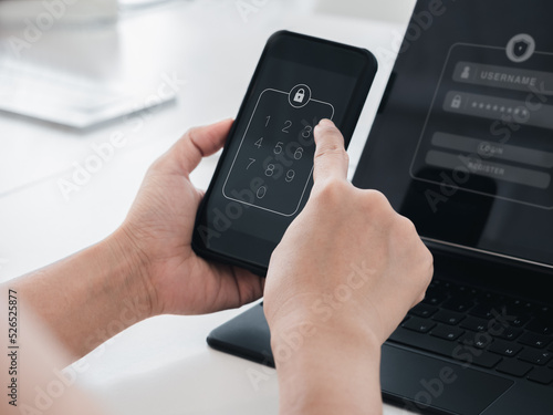 Two steps authentication or 2FA concept. Numbers passcode, lock code icon on smart mobile phone screen in hand with laptop for validate password page, Identity verification, cyber security technology.