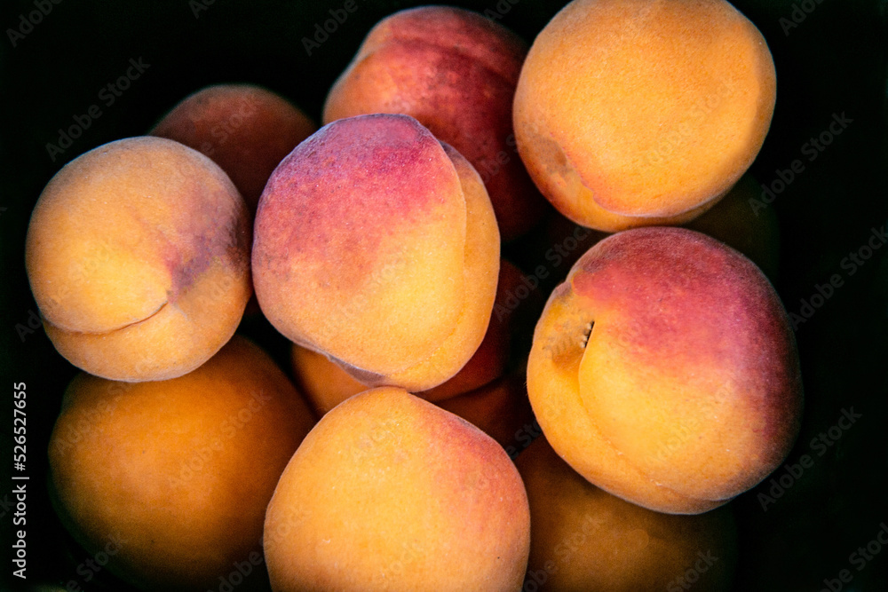 Ripe fresh peaches on a black background. Beautiful peaches. Close-up Ripe fresh peaches on a black background. Beautiful peaches. Close-up