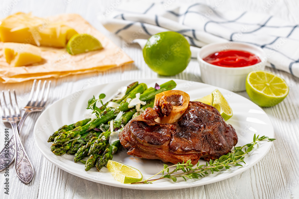 braised osso buco with grilled asparagus, top view braised osso buco with grilled asparagus, top view