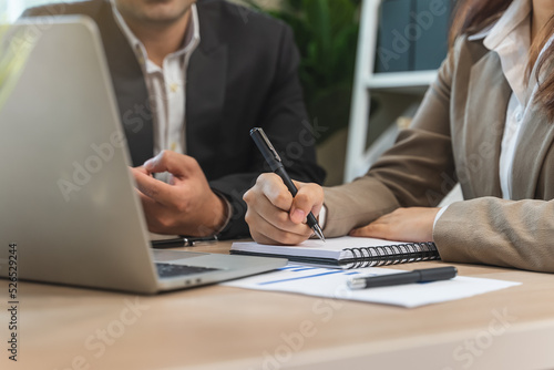 financial advisory services. Asian advisor showing plan of investment to clients in the consultancy office