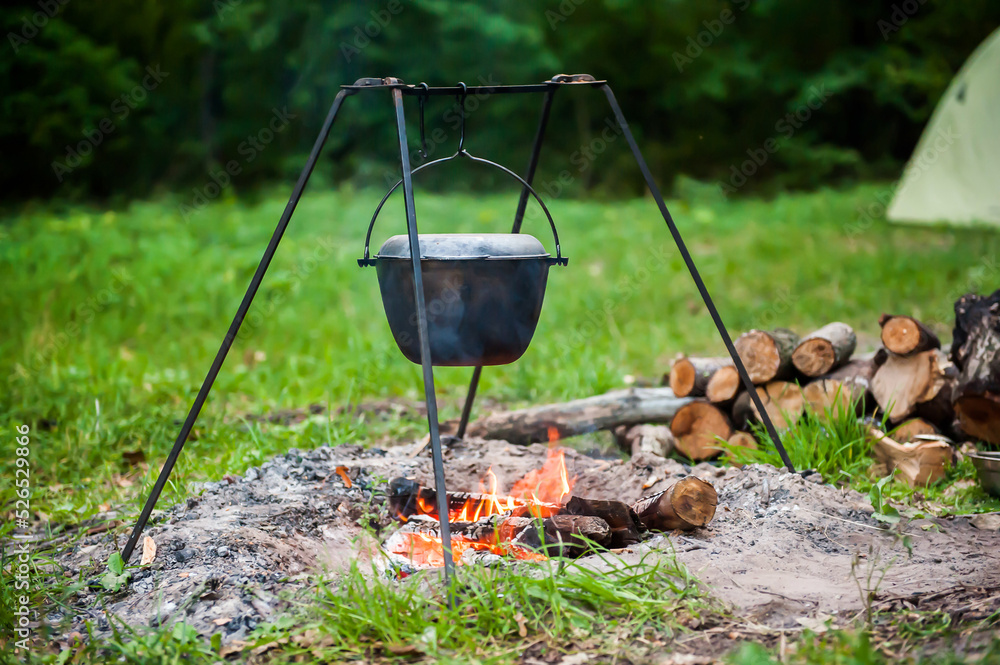 Cooking on a campfire in summer in nature. Bonfire and pot close-up Cooking on a campfire in summer in nature. Bonfire and pot close-up