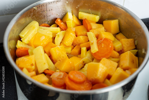 Vegetables for pumpkin soup are fried and languished in a saucepan