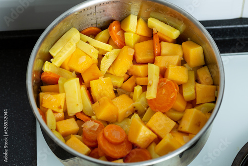 Vegetables for pumpkin soup are fried and languished in a saucepan