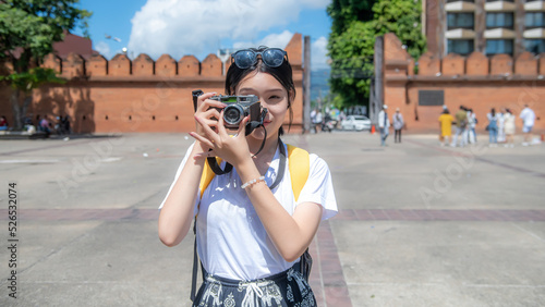 Asian woman traveling with a backpack travels to Tha Phae Gate in the old city of Chiang Mai in Chiang Mai, Thailand. photo