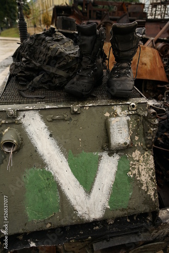 Army boots of a soldier on the armor of a landing vehicle. 