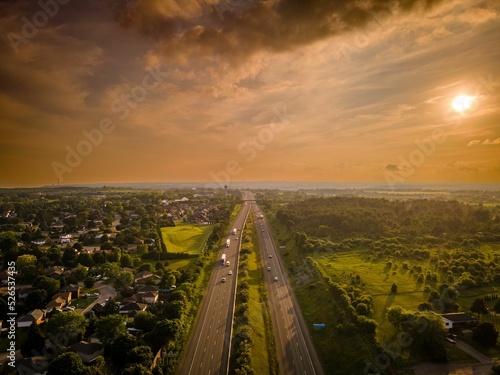 Drone view of the Port Hope streets surrounded by buildings and nature during a colorful sunset photo