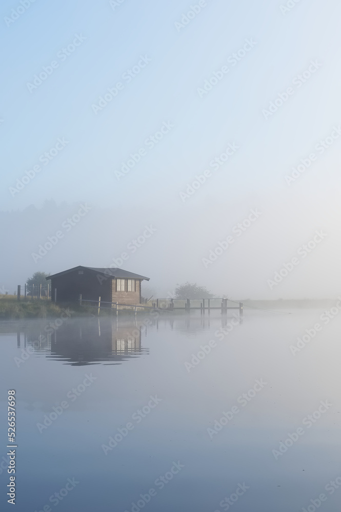 Fishing boats in lake and early morning mist at sunrise Fishing boats in lake and early morning mist at sunrise
