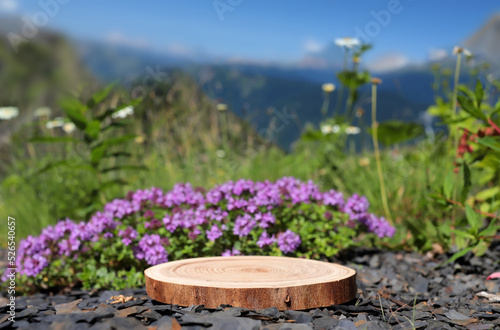 A slab with flowers is a Podium with a view of the mountains. The front showcase with a stage for products. A pedestal for the presentation of goods.