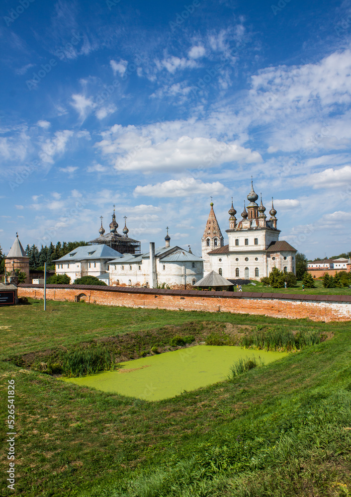 Beautiful panorama of the old Kremlin with historical churches and a stone fortress wall in Yuriev-Polsky, Vladimir region, Russia at sunny summer day