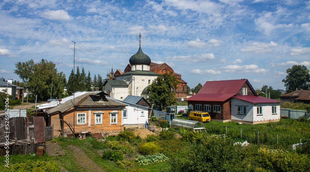Panoramic view of the old town of Yuriev-Polsky Russia with wooden houses among the green foliage of trees on a sunny summer day