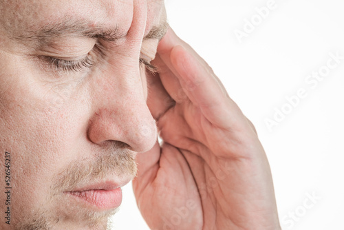 man with headache holding his head with his eyes closed