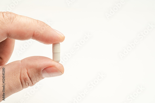 medical capsule with medicine in hand on a white isolated background