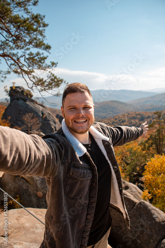 man hiker taking selfie on the top of dovbush rocks Ukraine photo