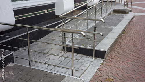 metal steel railings facade path near the building, path for the arrival for lifting disabled people