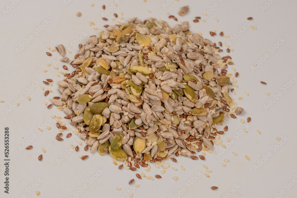 Mix of seeds for a salad. A pile of mixed seeds isolated on white background. Mix of seeds for a salad. A pile of mixed seeds isolated on white background.