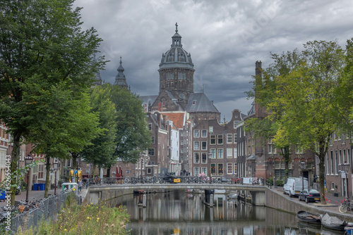 Canal and Cathedral in Amsterdam Before Rain