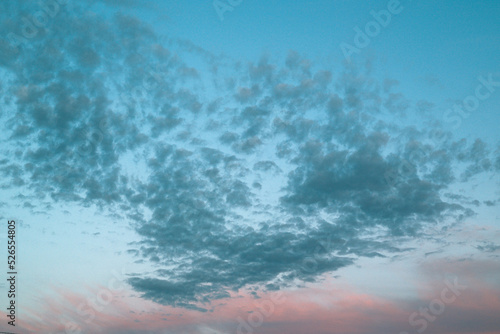 Background from the clouds at sunset or dawn with space for text. Blue clouds in sunset.