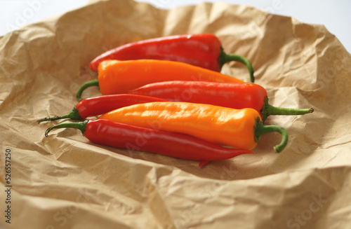 Pepper fruits on wrapping paper. The process of cooking. Healthy food concept. Superfood. photo