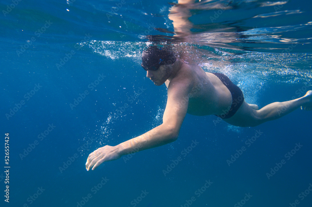 Sporty man swims fast in the sea Sporty man swims fast in the sea