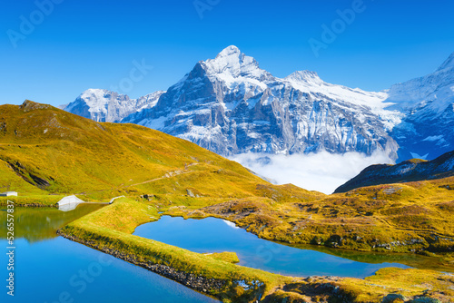 Grindelwald, Switzerland. High mountains and reflection on the surface of the lake. Mountain valley with lake. Landscape in the highlands in the summertime. © biletskiyevgeniy.com