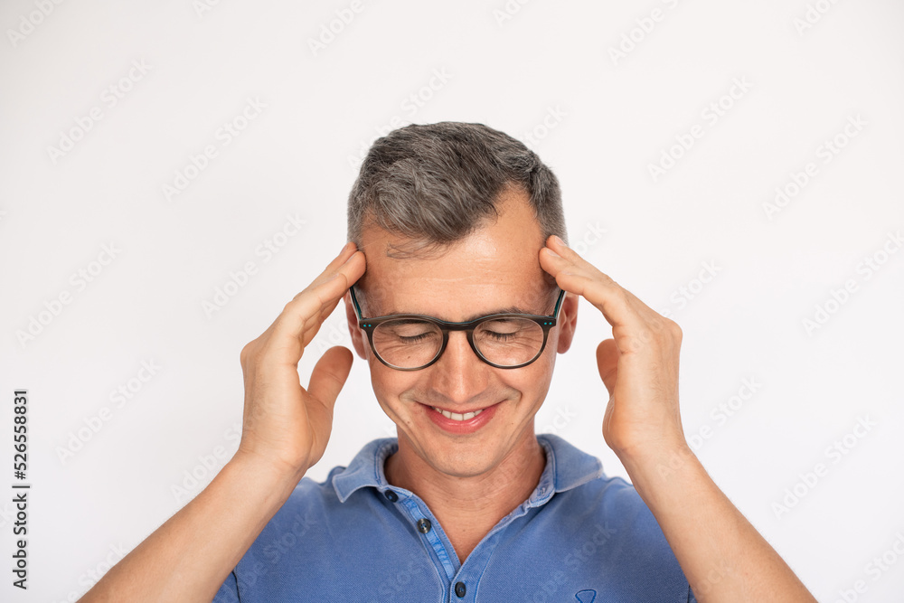Portrait of concentrated man in glasses. Mid adult male model in T-shirt touching temples. Portrait, studio shot concept Portrait of concentrated man in glasses. Mid adult male model in T-shirt touching temples. Portrait, studio shot concept