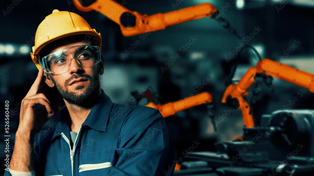 Engineer use cybernated robotic software to control industry robot arm ...