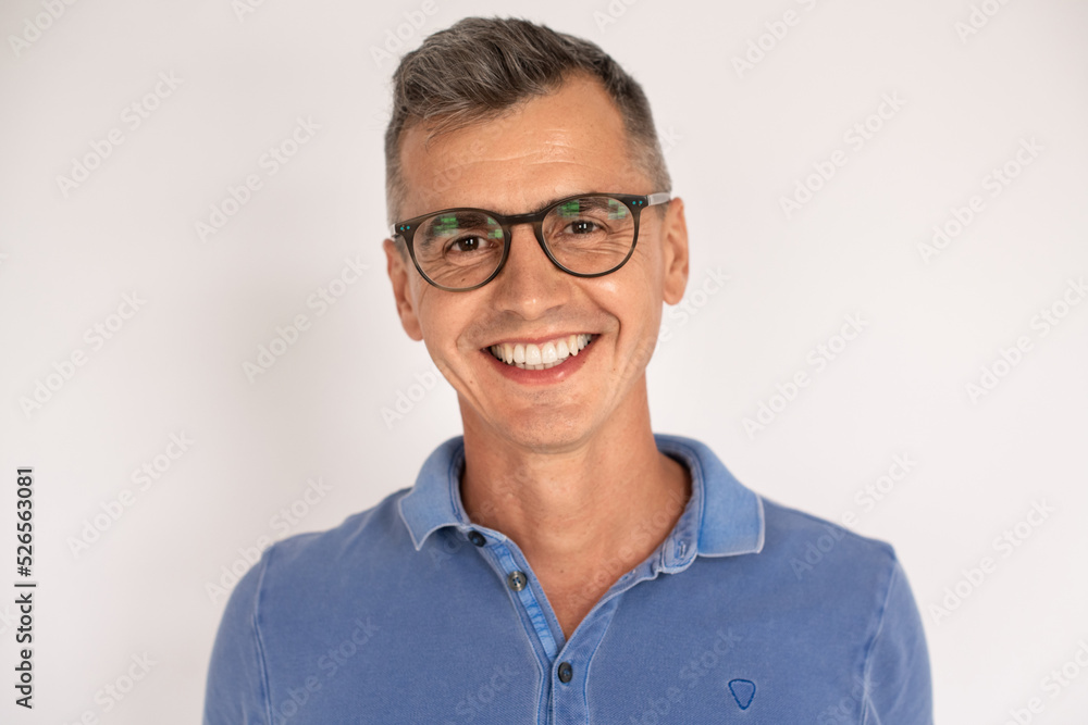 Portrait of smiling handsome man in glasses. Mid adult male model in T-shirt looking at camera. Portrait, studio shot concept