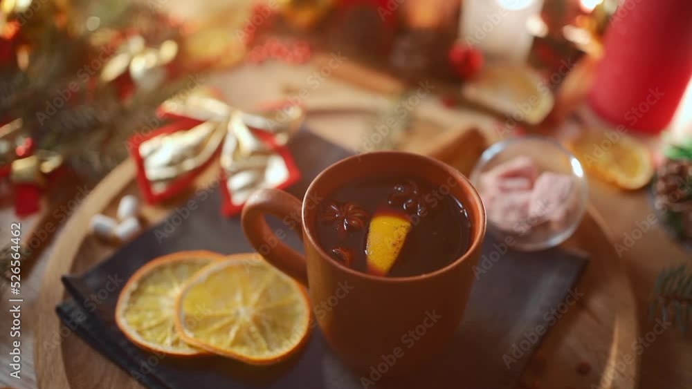 mulled red wine gluhwine in cup with orange, christmas decor table with candles mulled red wine gluhwine in cup with orange, christmas decor table with candles