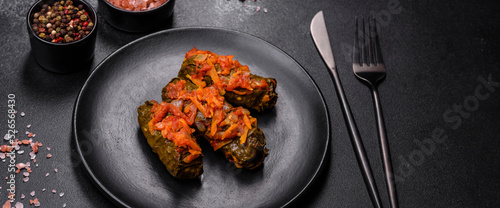 Dolma, stuffed grape leaves with rice and meat on a dark background photo